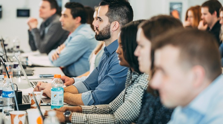 Business students concentrate in a classroom during a presentation