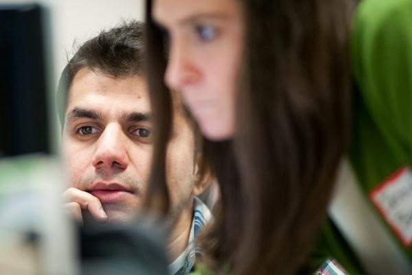 An international student gets help from a staff member at Ohio University on a computer