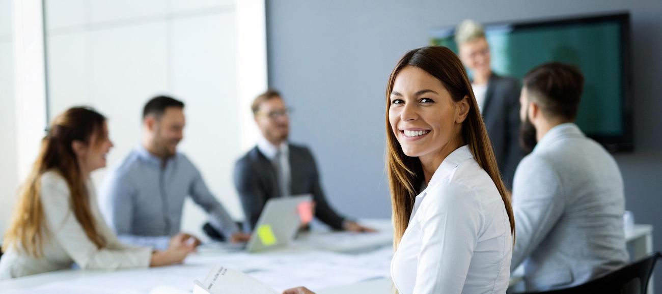 A woman smiles during a business meeting