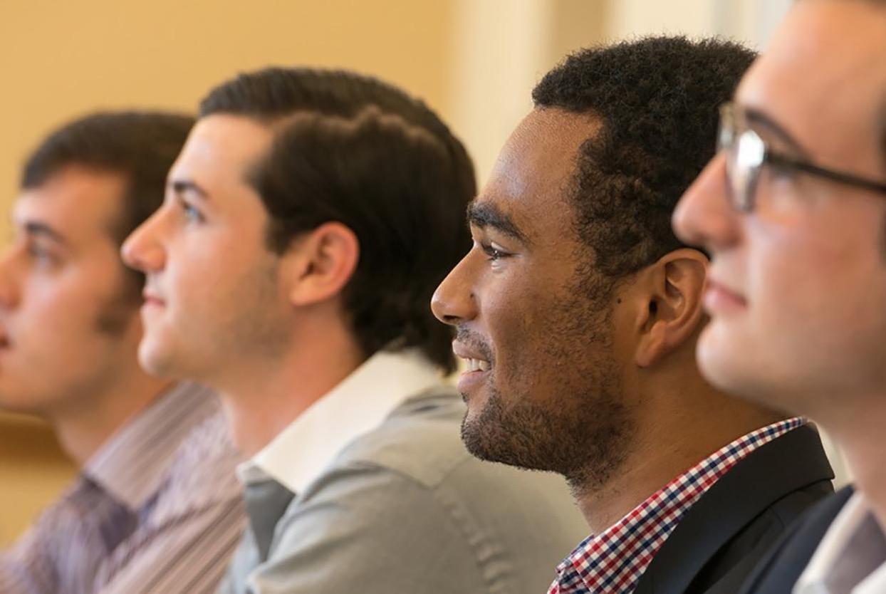 Business students smile and listen during a lecture