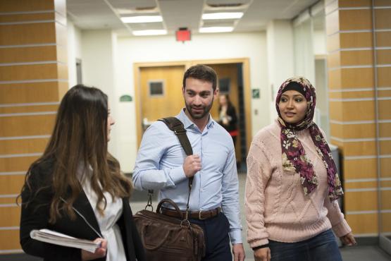 group of MBA students walking to work in the College of Business Annex