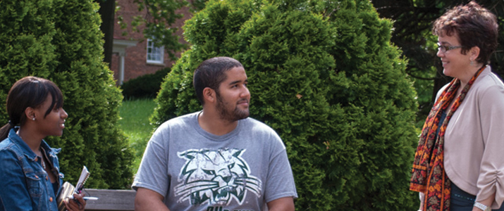 Students speaking with Professor outside