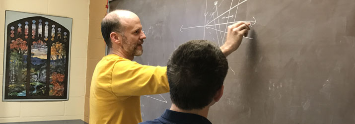 Image of Dr. Martin Mohlenkamp working through a research question with Ph.D. candidate Nathaniel McClatchey.