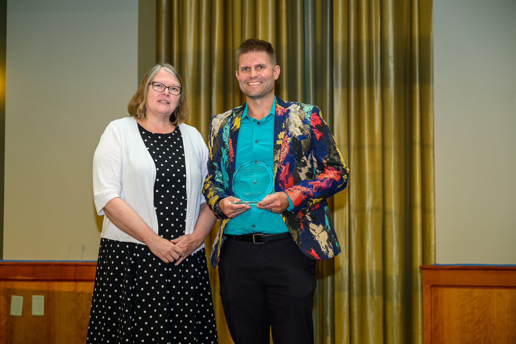 Image of Provost Dr. Elizabeth Sayrs and Dr. Corey Beck, holding the  Provost's Award for Excellence in Teaching.