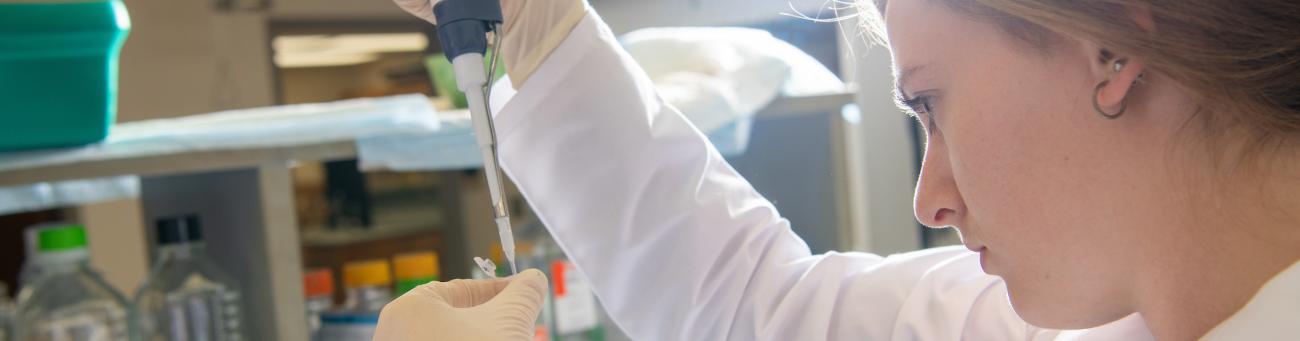 Student uses syringe in a lab