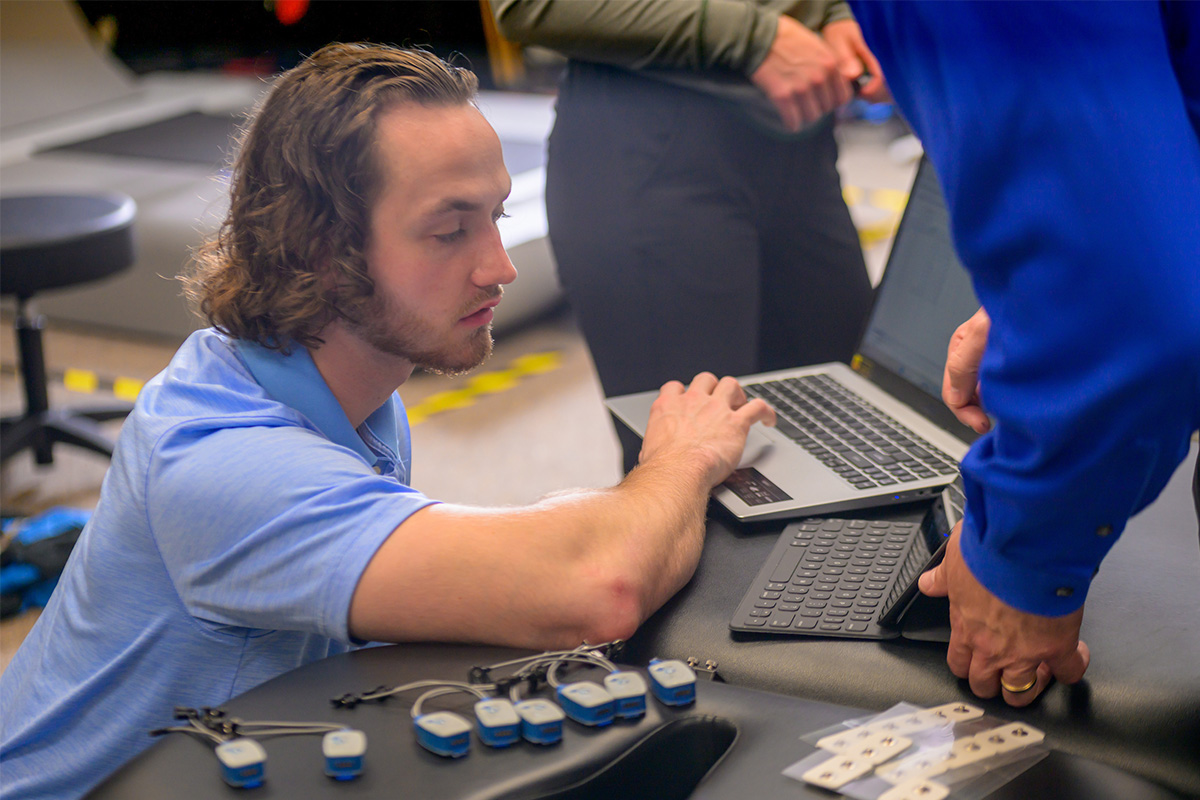 An instructor shows a student what to look for on a computer screen.