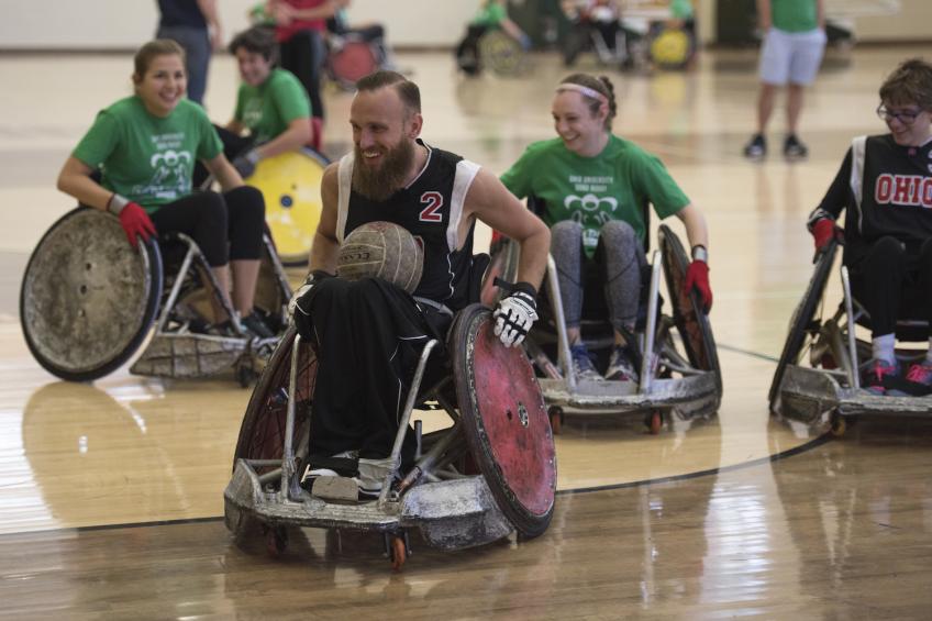 students playing quad rugby in gym