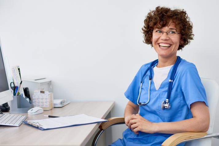 nurse smiling at desk