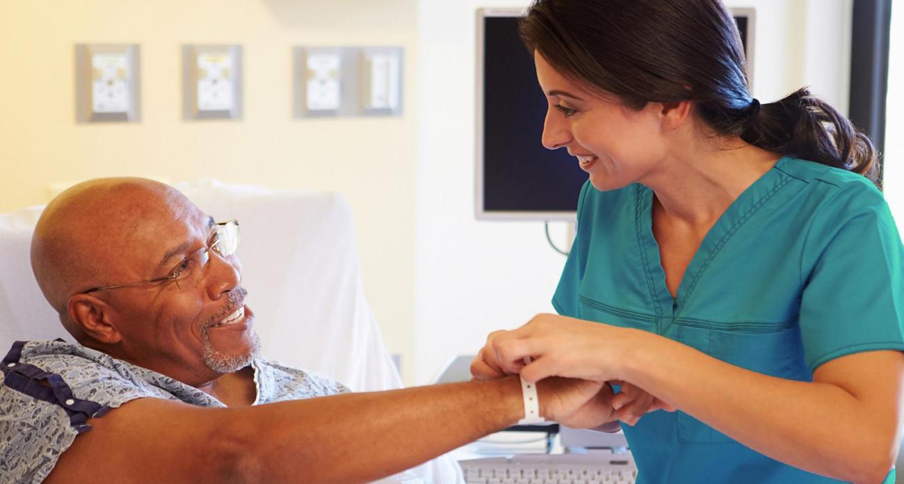 A nurse helps a patient in a hospital