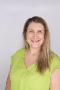 Headshot of Marianne Jacobs, wearing a green shirt and smiling