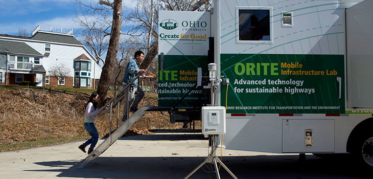 ORITE Mobile Infrastructure lab in parking lot, with two people walking up a staircase to the back door of the trailer