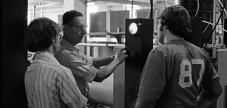 People standing in front of device