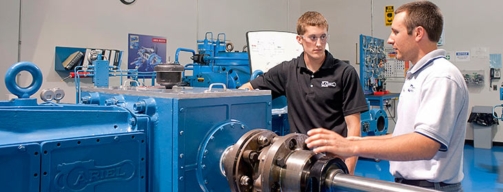 Student receiving instructions from a worker at their internship.