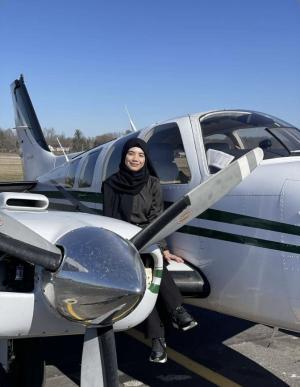 Nilufer Yavuz next to an airplane