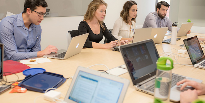 Students viewing books and computers