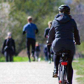 People walking and biking on a bike path