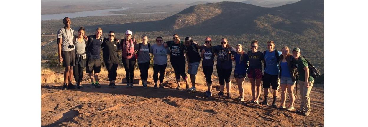 OHIO students in Botswana with beautiful mountains behind.