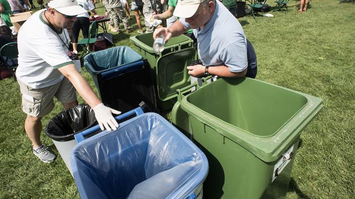 Two people recycling