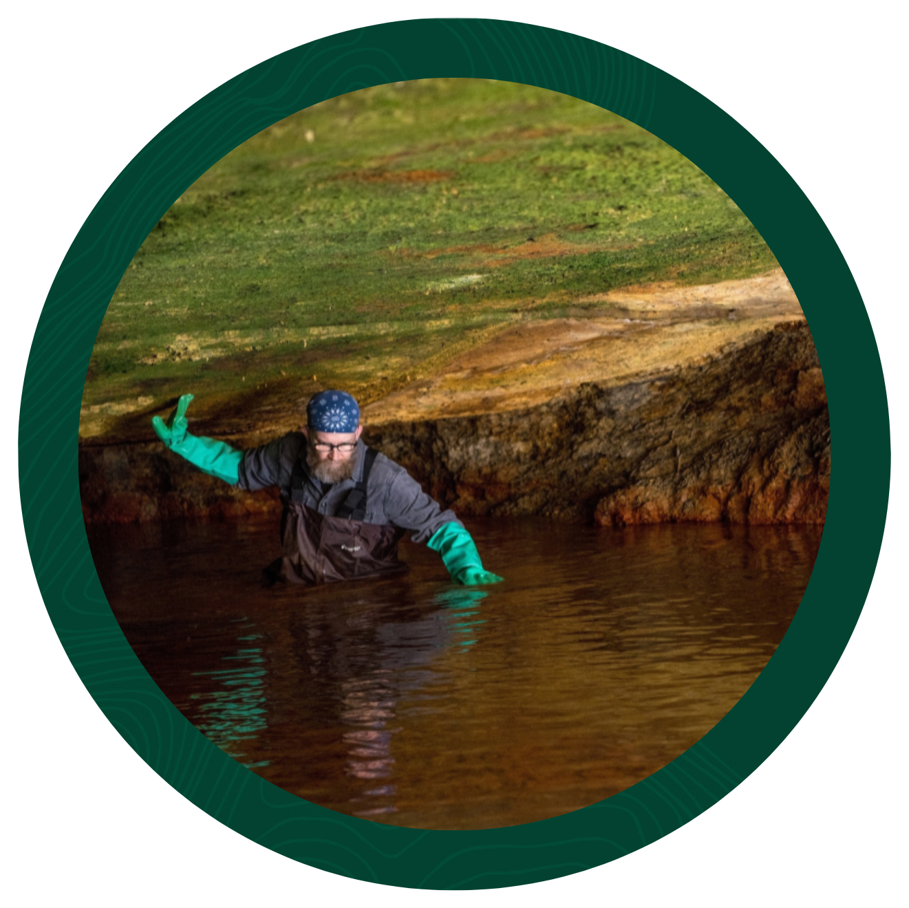 Man in cave with water up to his waste.