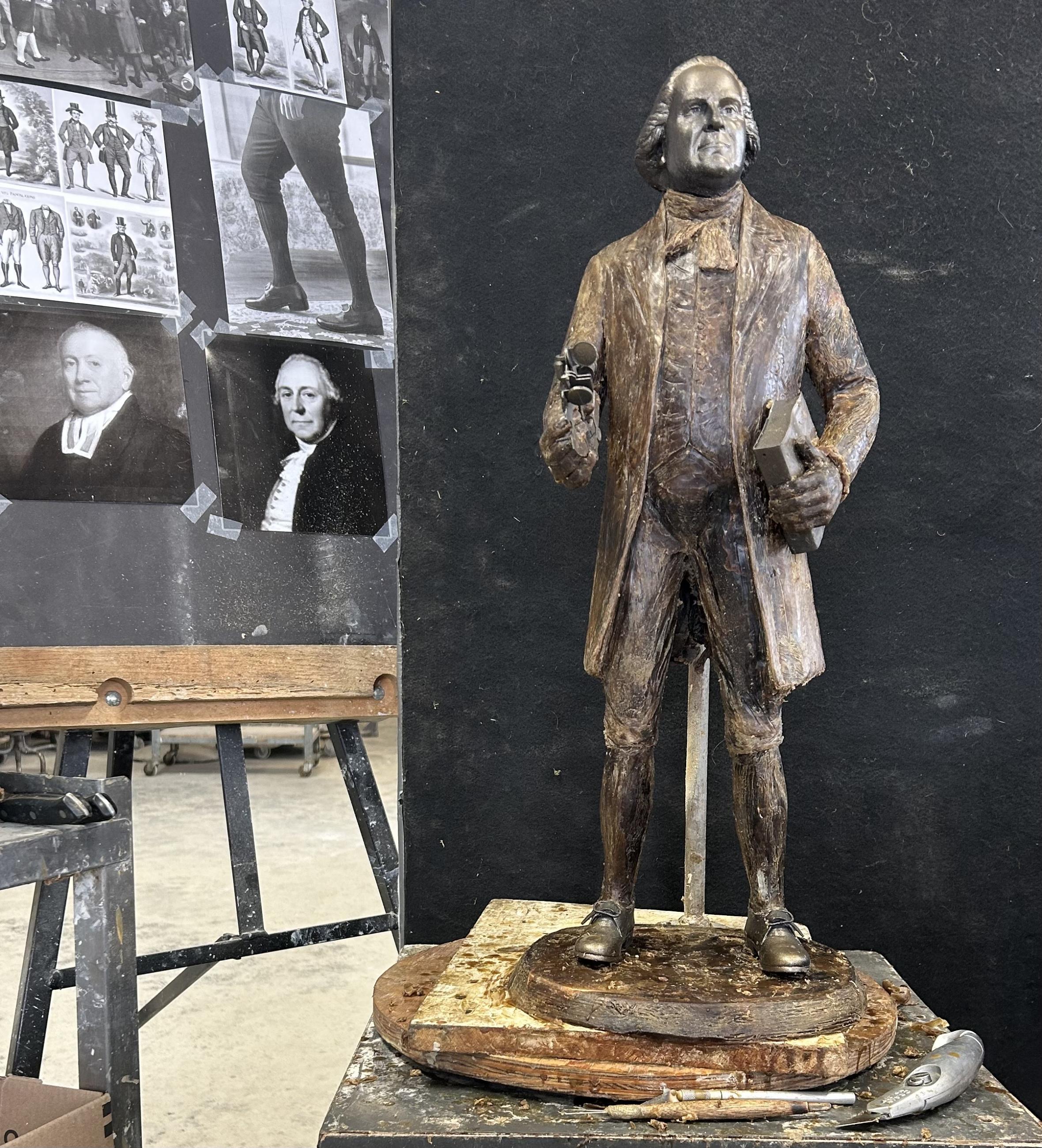 A model of a Manasseh Cutler statue standing next to photo inspiration.