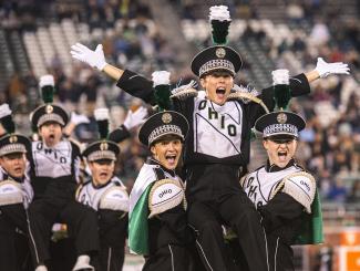 Members of the Marching 110 perform at a football game