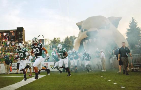 Football players charge the field