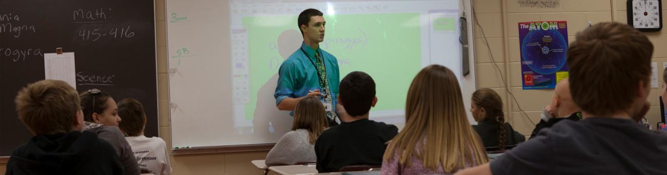 College student teaching middle school science class