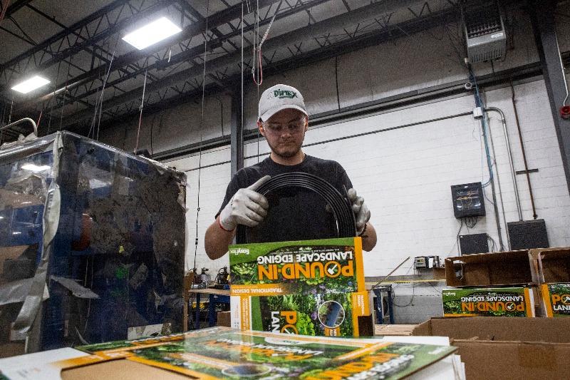 A boy packages landscaping tools